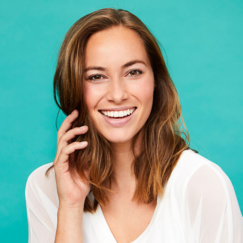 Woman with Beautiful Smile holding her hair