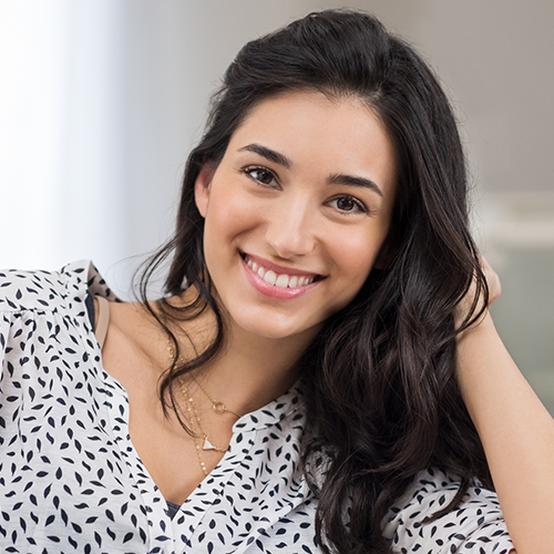Black Haired beautiful Woman Smiling while her hands on her hair